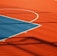 A vibrant sports court with sections of red and blue, featuring crisp white lines marking the boundaries. Shadows from a structure create geometric patterns across the surface, adding depth and interest to the scene.